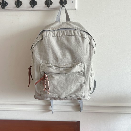 Japanese and Korean style washed canvas backpack with small floral rope, simple, fashionable, retro, versatile, and artistic style.
