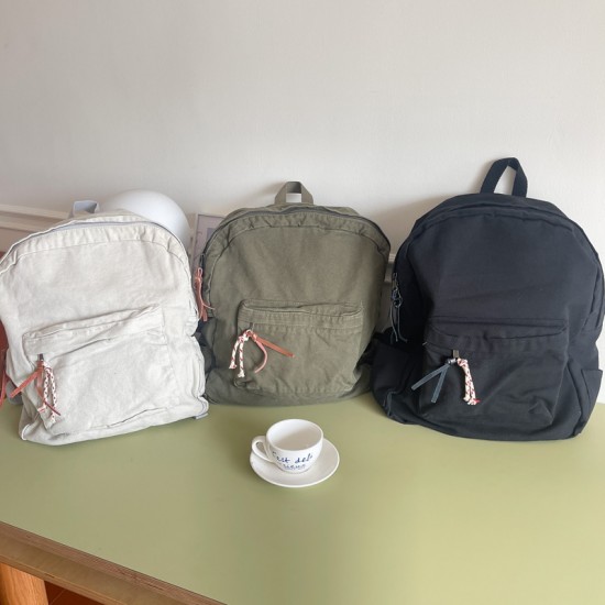 Japanese and Korean style washed canvas backpack with small floral rope, simple, fashionable, retro, versatile, and artistic style.