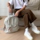 Japanese and Korean style washed canvas backpack with small floral rope, simple, fashionable, retro, versatile, and artistic style.